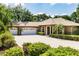 Stunning home with mature landscaping, a wide driveway, and a three-car garage that enhances its curb appeal at 17358 Hwy 27, Clermont, FL 34715