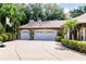 Expansive three-car garage showcasing ample parking space and enhanced curb appeal on a sunny day at 17358 Hwy 27, Clermont, FL 34715