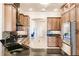 Bright kitchen featuring wood cabinets, a breakfast bar, and modern appliances at 17358 Hwy 27, Clermont, FL 34715