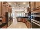 Spacious kitchen with wooden cabinetry, stainless steel appliances, and black granite countertops at 17358 Hwy 27, Clermont, FL 34715