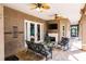 Covered patio area featuring comfortable seating, a fireplace, and a serene outdoor living space at 17358 Hwy 27, Clermont, FL 34715