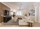 Bright living room featuring an open layout with a large sofa, ceiling fan, and natural light at 17358 Hwy 27, Clermont, FL 34715