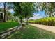 Well-maintained yard showcases lush green grass and mature trees, creating a picturesque outdoor setting at 17358 Hwy 27, Clermont, FL 34715