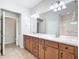 Bright bathroom featuring a double vanity, tile flooring and a separate shower and toilet room at 9582 Sw 70Th Loop, Ocala, FL 34481