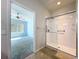 This bathroom features a modern glass enclosed shower with tiled floor, towel bars, and tile flooring at 9582 Sw 70Th Loop, Ocala, FL 34481