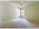 This carpeted bedroom features a ceiling fan and window at 9582 Sw 70Th Loop, Ocala, FL 34481