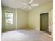 This bedroom has a window, a ceiling fan, and a closet at 9582 Sw 70Th Loop, Ocala, FL 34481