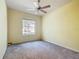 This bedroom has a window and a ceiling fan at 9582 Sw 70Th Loop, Ocala, FL 34481