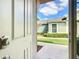 View from the home's interior looking out to a bright view of the front lawn at 9582 Sw 70Th Loop, Ocala, FL 34481