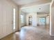Bright foyer with tile floors, a double-door entry, and a view of the open floor plan at 9582 Sw 70Th Loop, Ocala, FL 34481
