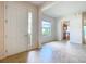 Welcoming foyer boasts tile flooring, double-door entry, and a glimpse of the modern kitchen at 9582 Sw 70Th Loop, Ocala, FL 34481