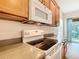 Close-up of the kitchen featuring modern electric stove and microwave at 9582 Sw 70Th Loop, Ocala, FL 34481