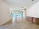 Open-concept living space with tile floors, recessed lighting, and sliders leading to a screened outdoor area at 9582 Sw 70Th Loop, Ocala, FL 34481