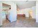 Open-concept living room with tile floors, cabinetry, and access to the kitchen and bathroom at 9582 Sw 70Th Loop, Ocala, FL 34481