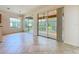Bright living room featuring tile floors, sliding glass doors to screened patio, and ample natural light at 9582 Sw 70Th Loop, Ocala, FL 34481