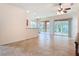 Open living area with tile flooring, sliding glass doors leading to a screened lanai, and neutral color palette at 9582 Sw 70Th Loop, Ocala, FL 34481