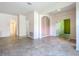 Spacious living room with tile flooring, neutral paint, and doorways to adjacent rooms at 9582 Sw 70Th Loop, Ocala, FL 34481