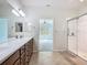 Ensuite bathroom featuring dual sinks, vanity, tiled floor, and glass enclosed shower in a well-lit space at 9582 Sw 70Th Loop, Ocala, FL 34481