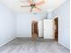 Large main bedroom features light blue walls, a ceiling fan, and doorways to the ensuite bathroom and closet at 9582 Sw 70Th Loop, Ocala, FL 34481