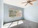 Bright main bedroom with large windows, ceiling fan, and neutral color scheme offering a relaxing ambiance at 9582 Sw 70Th Loop, Ocala, FL 34481