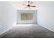 Light-filled main bedroom featuring a ceiling fan, large window, and a peaceful, inviting atmosphere at 9582 Sw 70Th Loop, Ocala, FL 34481