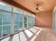 This tiled patio features a ceiling fan and sliding glass doors at 9582 Sw 70Th Loop, Ocala, FL 34481