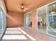 Inviting sunroom with tile floors, ceiling fan, and sliding glass doors for seamless indoor-outdoor living at 9582 Sw 70Th Loop, Ocala, FL 34481