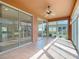 Bright sunroom with tile flooring, ceiling fan, and sliding glass doors overlooking the backyard at 9582 Sw 70Th Loop, Ocala, FL 34481