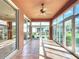 Spacious sunroom with tile floors, ceiling fan, and walls of windows offering lots of natural light at 9582 Sw 70Th Loop, Ocala, FL 34481