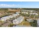 Aerial view of community buildings featuring a green space, pool, and plentiful parking spaces at 3120 Paradox Cir # 307, Kissimmee, FL 34746