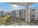 Balcony view showcasing the community's manicured green space and residential buildings at 3120 Paradox Cir # 307, Kissimmee, FL 34746