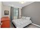 Comfortable bedroom with a gray accent wall, large window, and plush carpeting at 3120 Paradox Cir # 307, Kissimmee, FL 34746