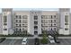 Modern condominium building featuring a sleek design with multiple floors and ample parking at 3120 Paradox Cir # 307, Kissimmee, FL 34746