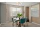Bright dining room features a modern light fixture, large window, and contemporary furnishings at 3120 Paradox Cir # 307, Kissimmee, FL 34746