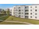 Close-up of the exterior featuring multiple balconies and a well-maintained lawn in a contemporary apartment complex at 3120 Paradox Cir # 307, Kissimmee, FL 34746