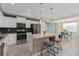 Well-appointed kitchen featuring stainless steel appliances, an island with seating, and dining area at 3120 Paradox Cir # 307, Kissimmee, FL 34746