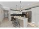 Modern kitchen with white cabinetry, stainless steel appliances, and a center island with seating at 3120 Paradox Cir # 307, Kissimmee, FL 34746