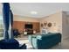 Cozy living room with blue furniture, modern lighting, and a mounted television at 3120 Paradox Cir # 307, Kissimmee, FL 34746