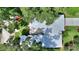 Overhead shot of a house boasting a well-maintained roof, manicured lawn, and mature trees at 3610 Pershing Ave, Orlando, FL 32812