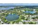 An aerial view of a home's proximity to a lake with lush green trees surrounding the area at 3610 Pershing Ave, Orlando, FL 32812