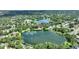 Aerial view of a property nestled between two lakes, surrounded by lush greenery and residential homes at 3610 Pershing Ave, Orlando, FL 32812