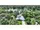 Aerial view of home on large treed lot, adjacent to a serene lake at 3610 Pershing Ave, Orlando, FL 32812