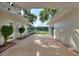 Tile patio between the main house and the screened-in porch with a view of the lake and backyard at 3610 Pershing Ave, Orlando, FL 32812