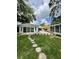 Beautiful backyard featuring lawn, stepping stones, and mature trees at 3610 Pershing Ave, Orlando, FL 32812