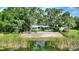 A waterfront home with a large backyard, enclosed patio and mature trees at 3610 Pershing Ave, Orlando, FL 32812