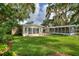 Lush green backyard with mature trees and well-maintained lawn, perfect for outdoor enjoyment and relaxation at 3610 Pershing Ave, Orlando, FL 32812