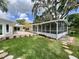 Well maintained backyard features a screened-in lanai, patio and lush landscaping at 3610 Pershing Ave, Orlando, FL 32812