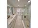 Modern bathroom featuring double sinks, white cabinets and a glass shower at 3610 Pershing Ave, Orlando, FL 32812