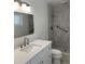 Clean bathroom featuring a tiled shower, vanity with drawers, and modern fixtures at 3610 Pershing Ave, Orlando, FL 32812