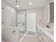 Well-lit bathroom showcasing double vanity, glass shower, and modern fixtures at 3610 Pershing Ave, Orlando, FL 32812